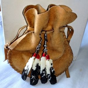 Hand painted carved Native American feather-shaped earrings in soft tan pouch.